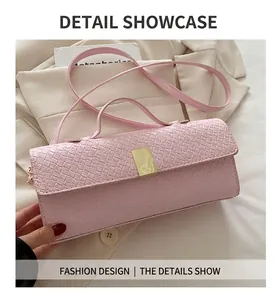 Close-up of light pink woven texture bag with golden metal buckle and thin shoulder strap