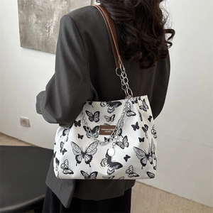 Chic butterfly print canvas tote bag with brown leather handles and silver chain