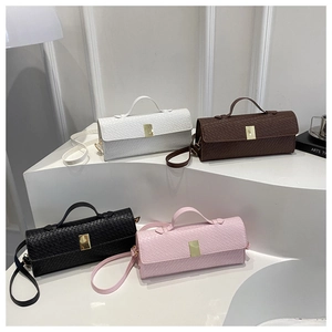 Detail view of woven leather texture shoulder bags in white, brown, black and pink colors