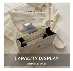 Overhead view showing the interior storage capacity for a smartphone in this cream bag