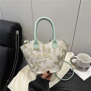 Chic vintage floral embroidered crossbody bag in creamy white with green handles