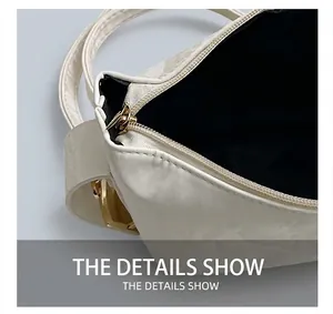 Detailed close-up of smooth white PU leather handbag with golden zipper and black lining