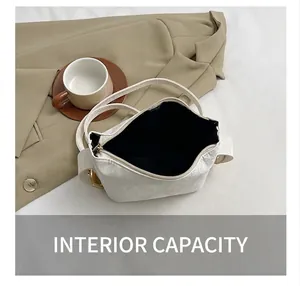 Top-down view of a white vintage pillow bag showing spacious black lining and metal zipper