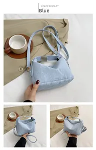 Detail of light blue PU handbag featuring a unique pleated texture and crossbody strap