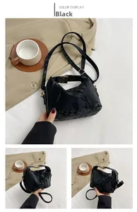 Detail of black pleated shoulder bag with vintage gold clasp and adjustable strap