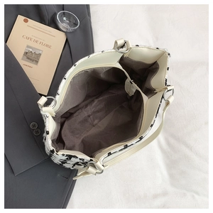 Detailed interior of tweed tote bag showing spacious compartments and dark lining