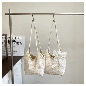 Detailed close-up of ivory lace tote bags with floral hollow pattern and decorative bow