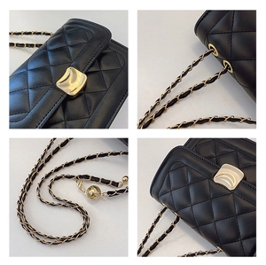 Detail shots of black quilted leather crossbody bag with gold wave lock and chain strap