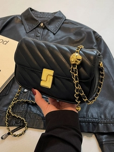 Black quilted crossbody bag with gold chain and adjustable decorative gold bead