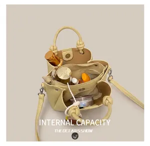 Top view of cream leather bucket bag interior showcasing spacious storage for cosmetics