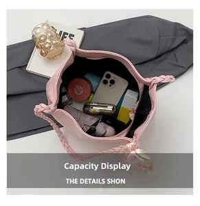 Top view of spacious pink tote bag interior holding umbrella, phone, and cosmetics