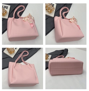 Detail view of pink quilted tote bag with woven handles and decorative floral ribbon