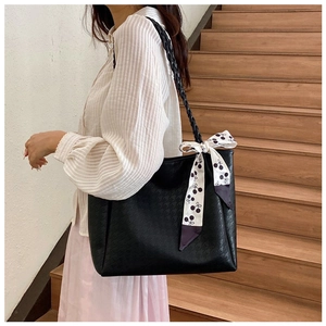 Detail of black tote bag with houndstooth texture and stylish cherry print scarf tie