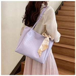 Detail of purple tote bag with houndstooth texture and floral silk scarf accessory