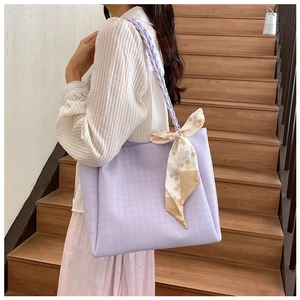 Close-up of lavender tote bag with braided strap and decorative silk scarf on stairs