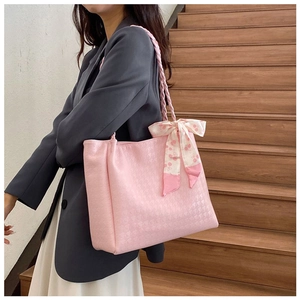 Pink houndstooth tote bag with cherry print scarf detail on a model in a city setting