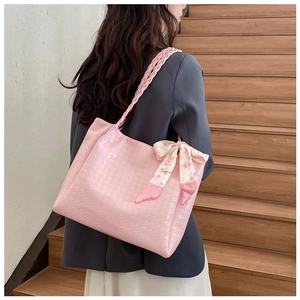 Pink jacquard tote bag detail with floral silk scarf bow and woven shoulder strap