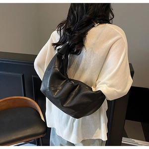 Detailansicht einer schwarzen Hobo-Tasche mit Faltenstruktur und Reißverschluss