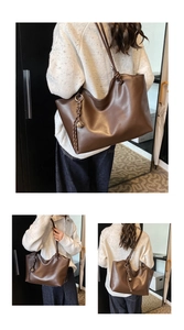 Detail shot of the dark brown leather tote bag showing knotted shoulder strap and bell charm