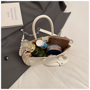 Top view of large cream leather handbag showing spacious interior for daily essentials