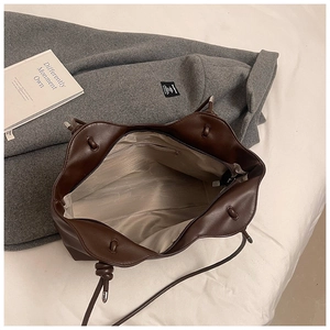 Detail view of large brown tote bag interior showing the zipper pocket and fabric lining