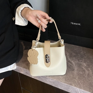 Sac seau chic en cuir beige et marron avec boucle en métal et charm chien mignon