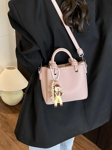 Pink lychee grain bucket bag with pearl doll pendant and adjustable strap for women