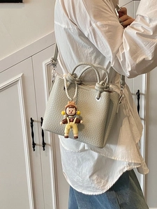Chic pale green lychee leather mini bucket bag with cute doll charm and shoulder strap