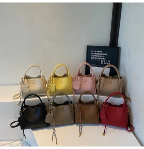 Close-up of litchi grain texture and magnetic buckle on multi-colored leather handbags