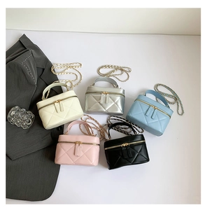 Top view of quilted mini vanity bags in five colors with chain straps and handles