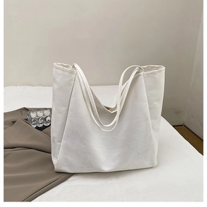Detail of white canvas tote bag with spacious interior for daily commute and shopping