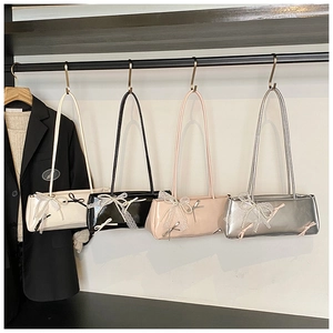 Macro detail of chic balletcore baguette bags featuring lace bows and pearl charms