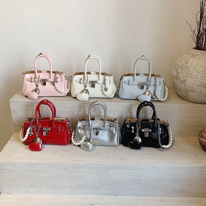 Chic commuter tote bags in assorted colors with metallic charms and pearl strap