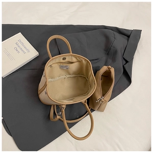 Detail view of khaki canvas tote bag interior with matching zipper pouch and magnetic buckle