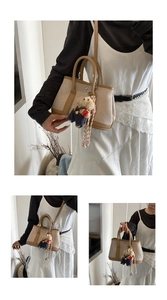 Detail of canvas bucket bag with brown leather trim and cute plush bear charm accessory