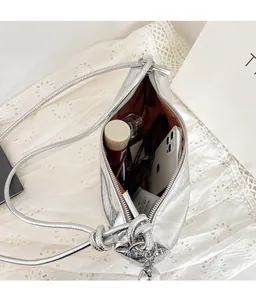 Interior view of the silver dumpling bag showing large capacity for phone and cosmetics