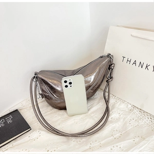 Detail of silver metallic hobo bag with smartphone inside showing interior capacity