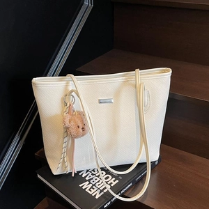 Minimalist white leather woven tote bag with silver logo and cute bear charm pendant