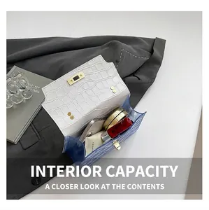 Detail showing daily capacity of the contrast leather handbag with phone and lipstick