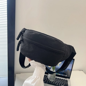 Black waterproof nylon crossbody waist bag with adjustable strap for daily use