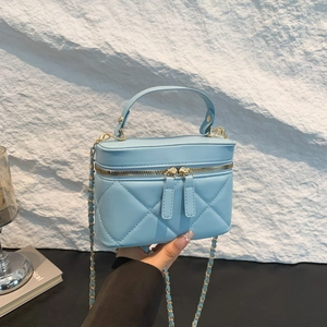 Light blue quilted leather vanity bag with gold chain strap and top handle style