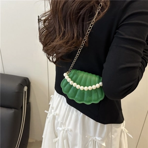 Chic green shell crossbody bag with pearl handle and gold chain strap for women