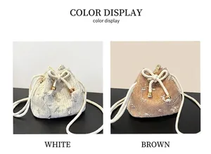 Detail of woven straw bucket bags featuring floral embroidery and cotton rope handles