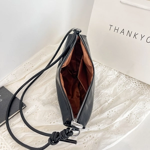 Minimalist black PU leather dumpling shoulder bag with spacious interior and knot strap