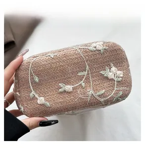Macro shot of durable woven base with floral embroidery on light pink bucket bag