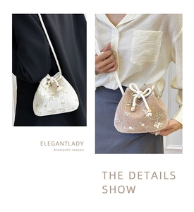 Detail show of woven straw bucket bags with floral embroidery and rope shoulder straps