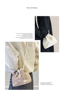 Detail of woven straw bucket bag featuring floral embroidery and pearl drawstring