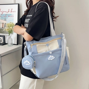 Blue and cream canvas tote bag with adjustable straps and cloud logo for students