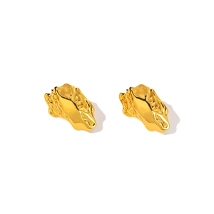 Detail shot of golden irregular lava texture stud earrings with metallic glossy finish