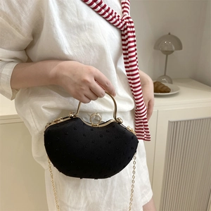 Mini heart-shaped black crossbody bag with vintage gold handle and diamond accents